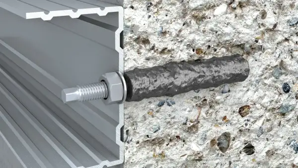 Przekrój pokazuje, jak kotwy chemiczne mocują profil aluminiowy do betonu. Solidne i niezawodne rozwiązanie.